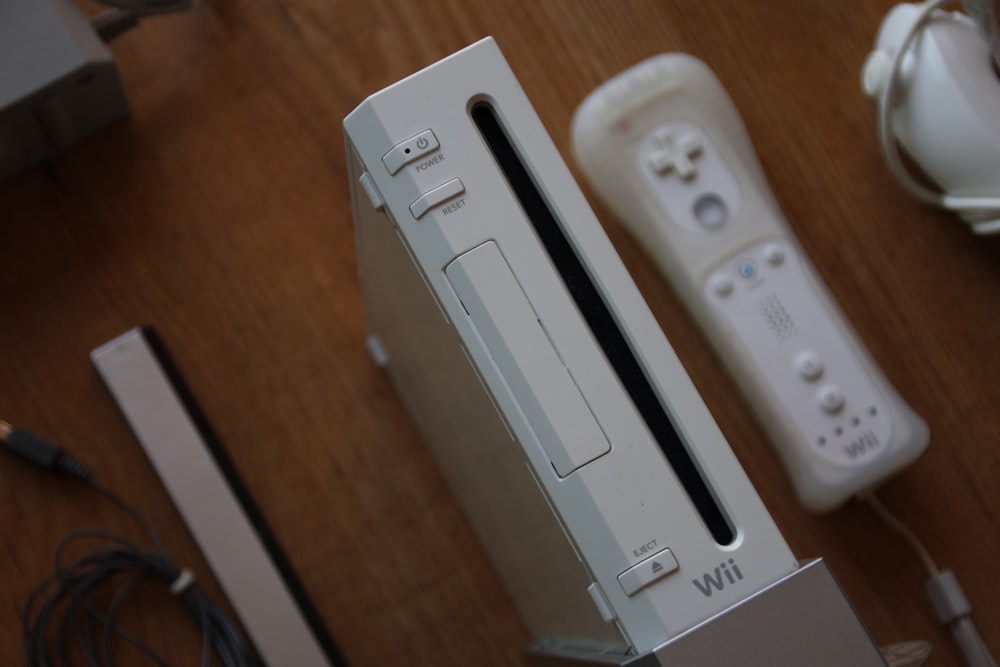 a nintendo wii game system sitting on top of a wooden table