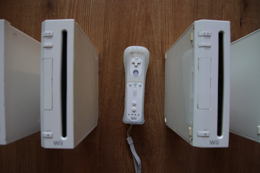 a nintendo wii game system sitting on top of a wooden table