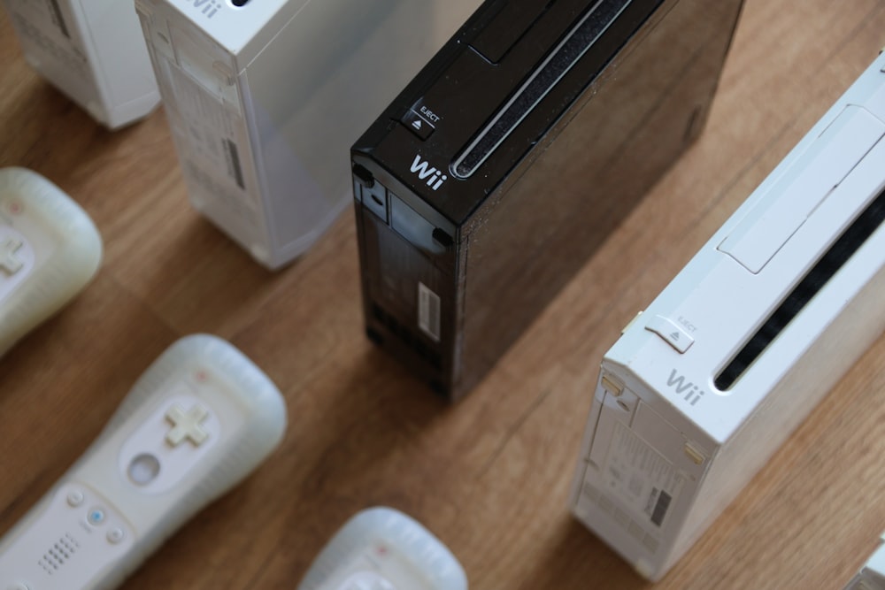 a group of video game controllers sitting on top of a wooden table