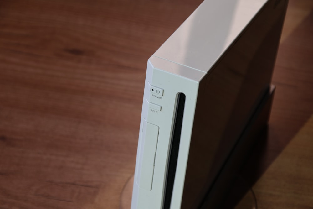 a close up of a white computer case on a wooden surface