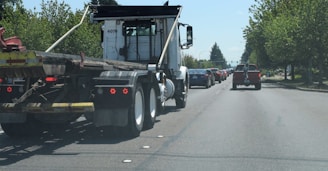 A busy highway scene featuring multiple USA-flag themed trucks moving smoothly in traffic.