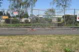 A team from Currier Construction setting up a chain-link fence on a rural property.