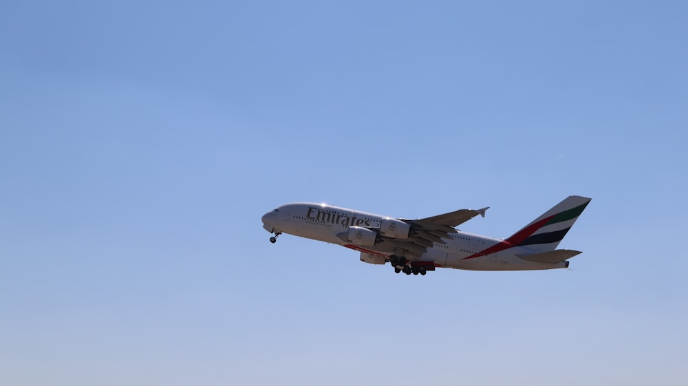 a large jetliner flying through a blue sky