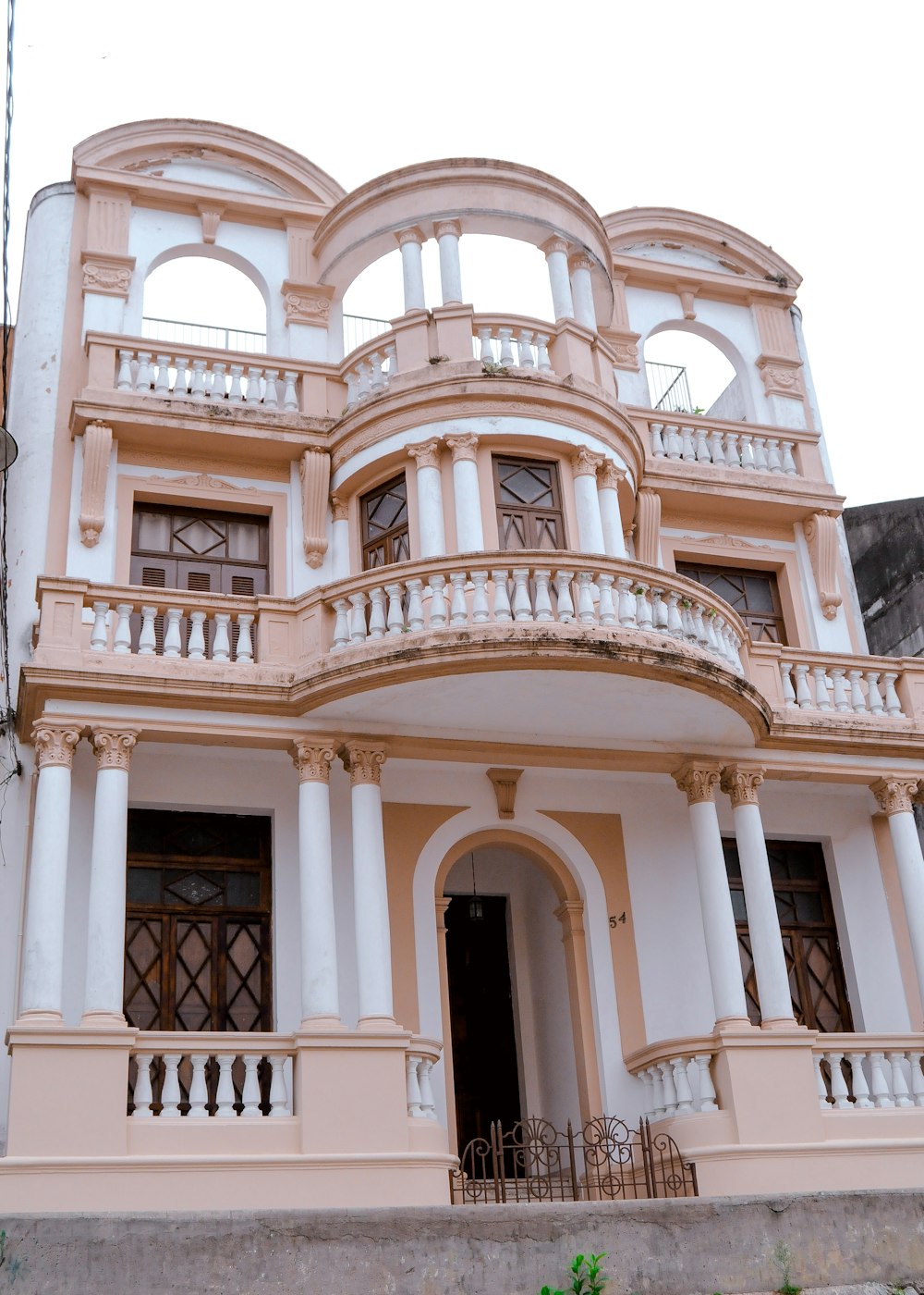 a pink and white building with balconies and balconies