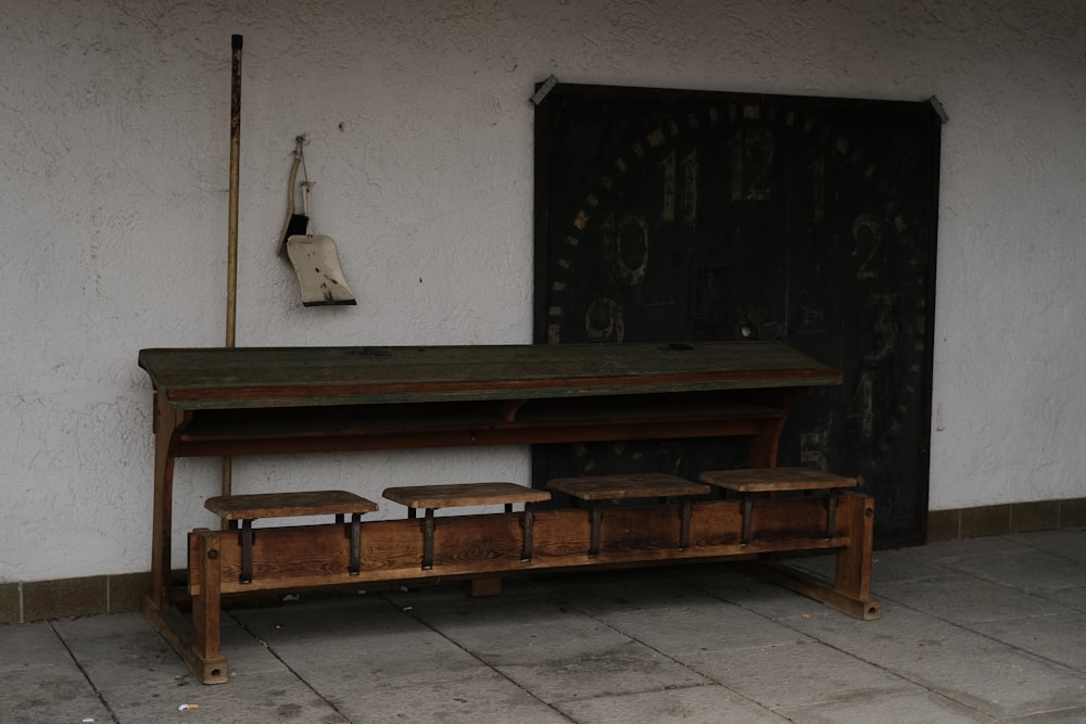 a wooden bench sitting in front of a door