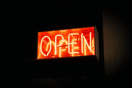 A vibrant orange Shopee logo glowing on a digital screen.