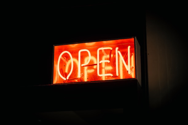 A vibrant storefront sign glowing under the Florida sun in downtown Orlando.