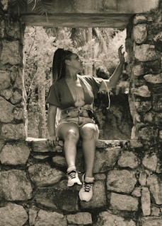 Ayesha enjoying a moment of reflection outdoors, embodying her adventurous spirit.