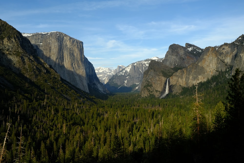 a view of a valley with mountains in the background