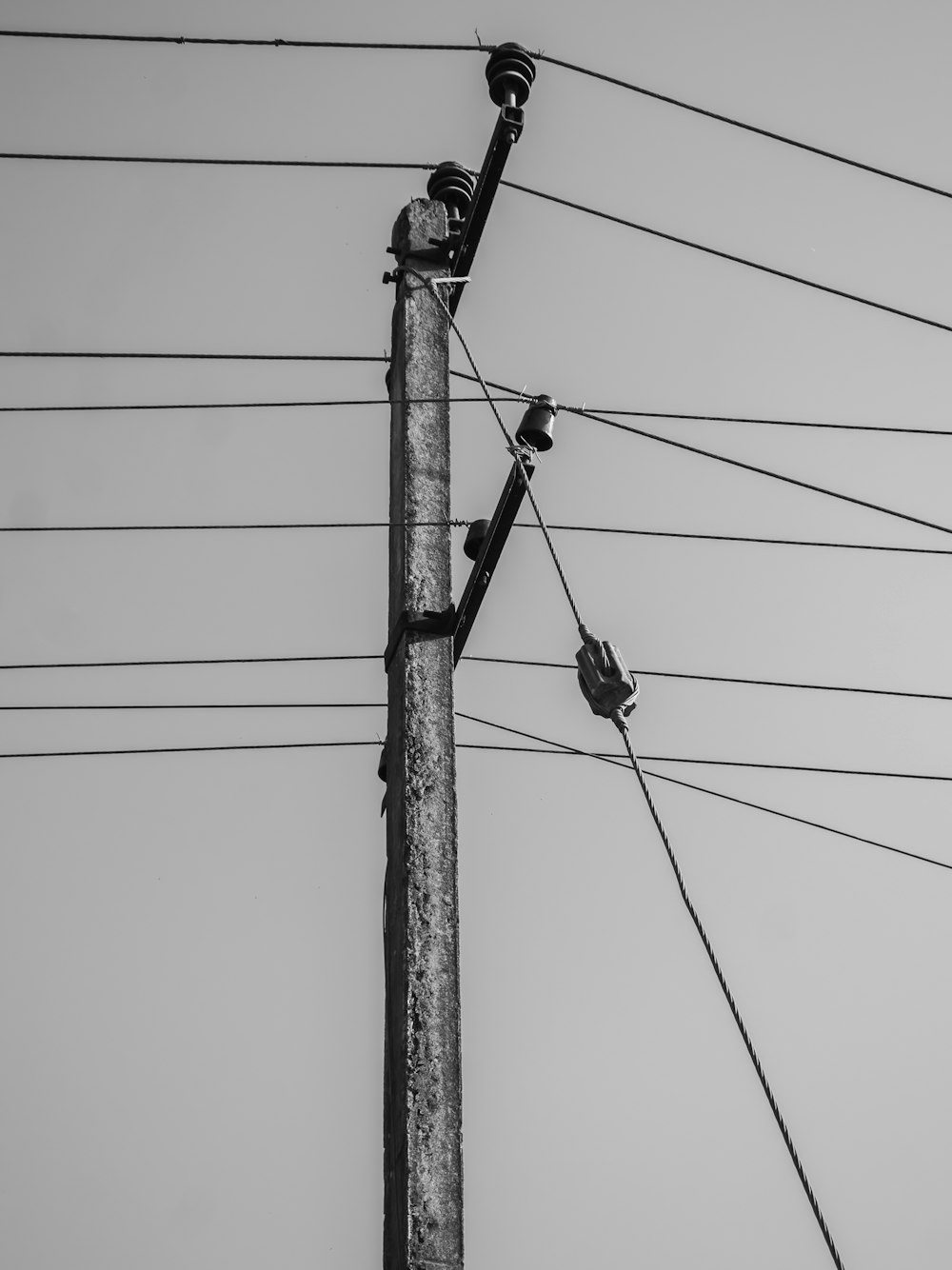 a black and white photo of a telephone pole