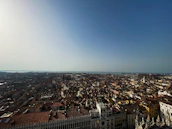 A panoramic view of Lisbon’s iconic rooftops under a clear blue sky.