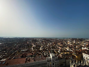 A panoramic view of Lisbon's colorful rooftops under a clear blue sky