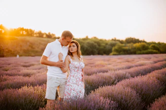 A romantic sunset photo shoot of a couple embracing near a lavender field in Provence.