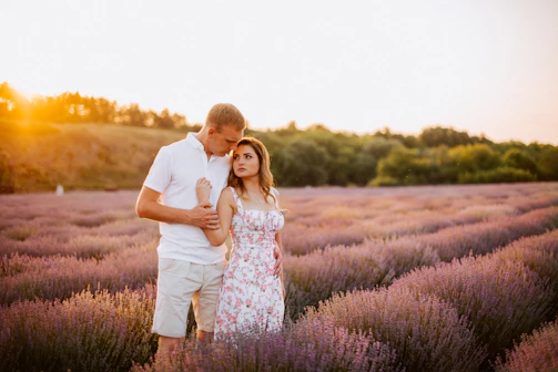 A romantic sunset photo shoot of a couple embracing near a lavender field in Provence.