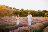 Couple walking hand-in-hand through the lavender fields of the Luberon.