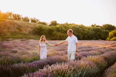 Couple walking hand-in-hand through the lavender fields of the Luberon.