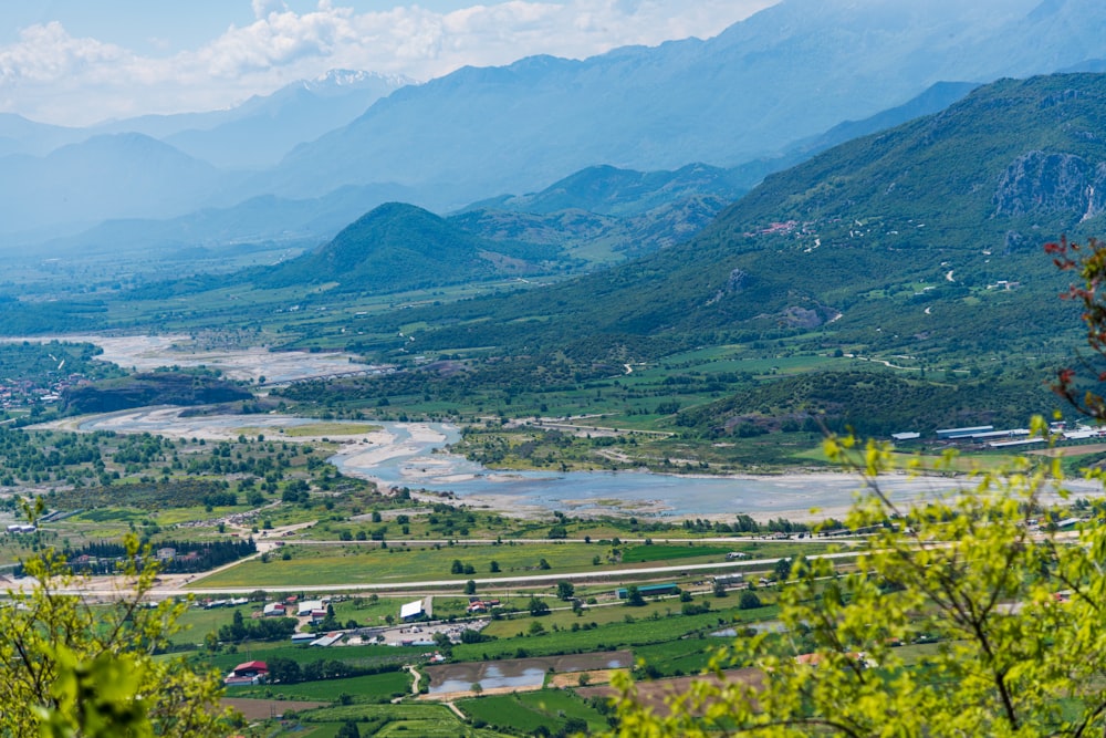 a scenic view of a valley with a river running through it