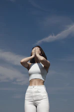 a woman standing in front of a blue sky