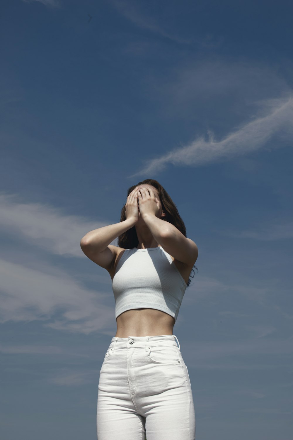 a woman standing in front of a blue sky