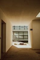 an empty hallway leading to a large building