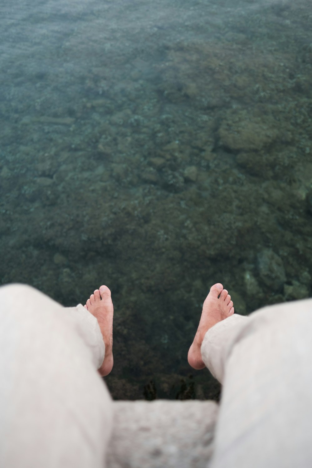 a person's feet sticking out of the water