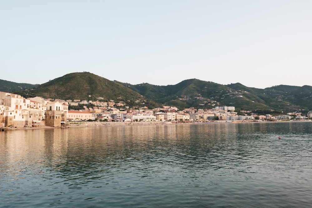 a body of water with a city in the background