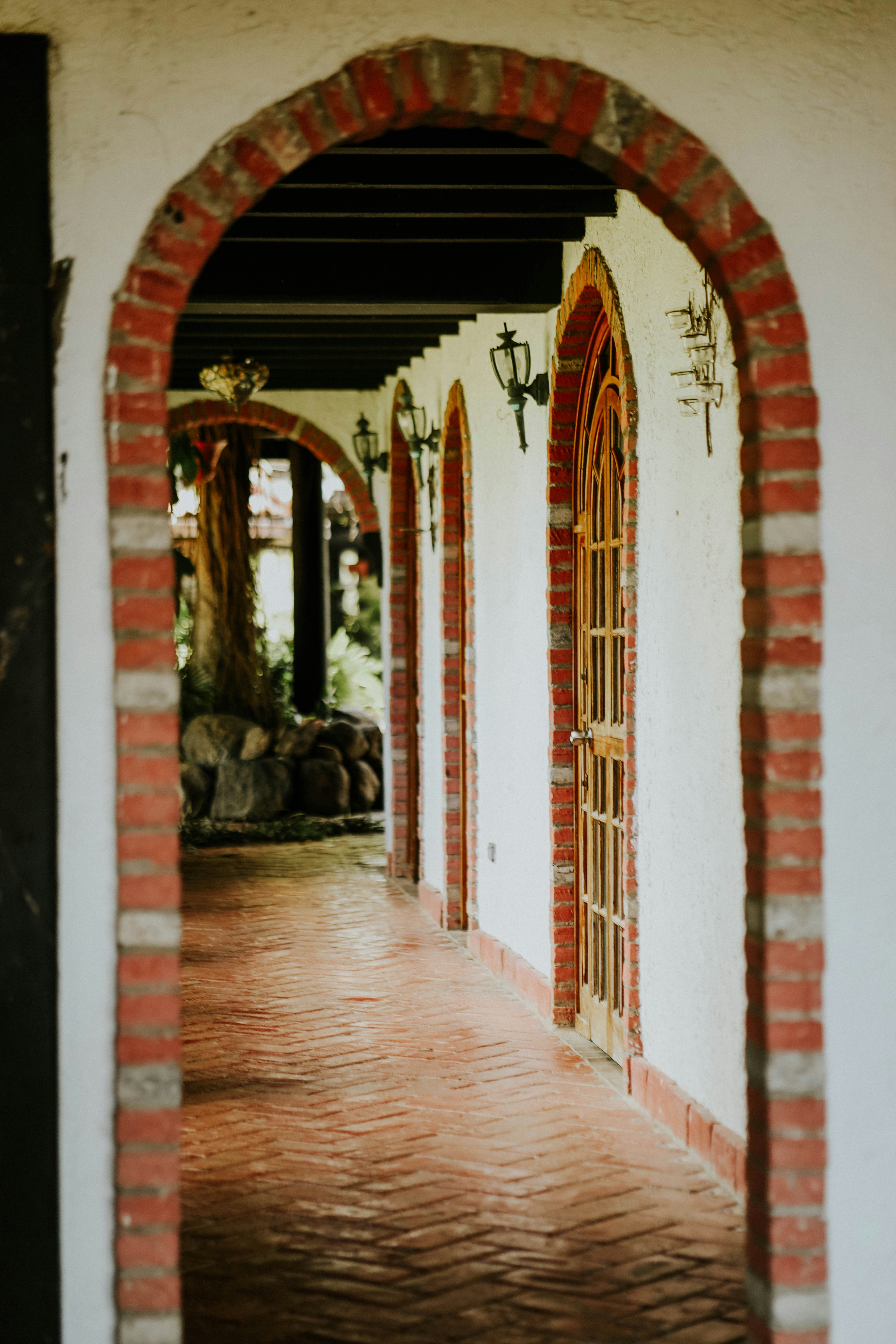an archway leading into a building with a clock on it