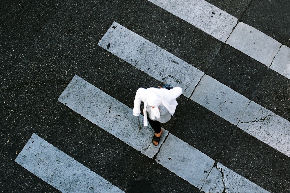 a person is walking across a cross walk