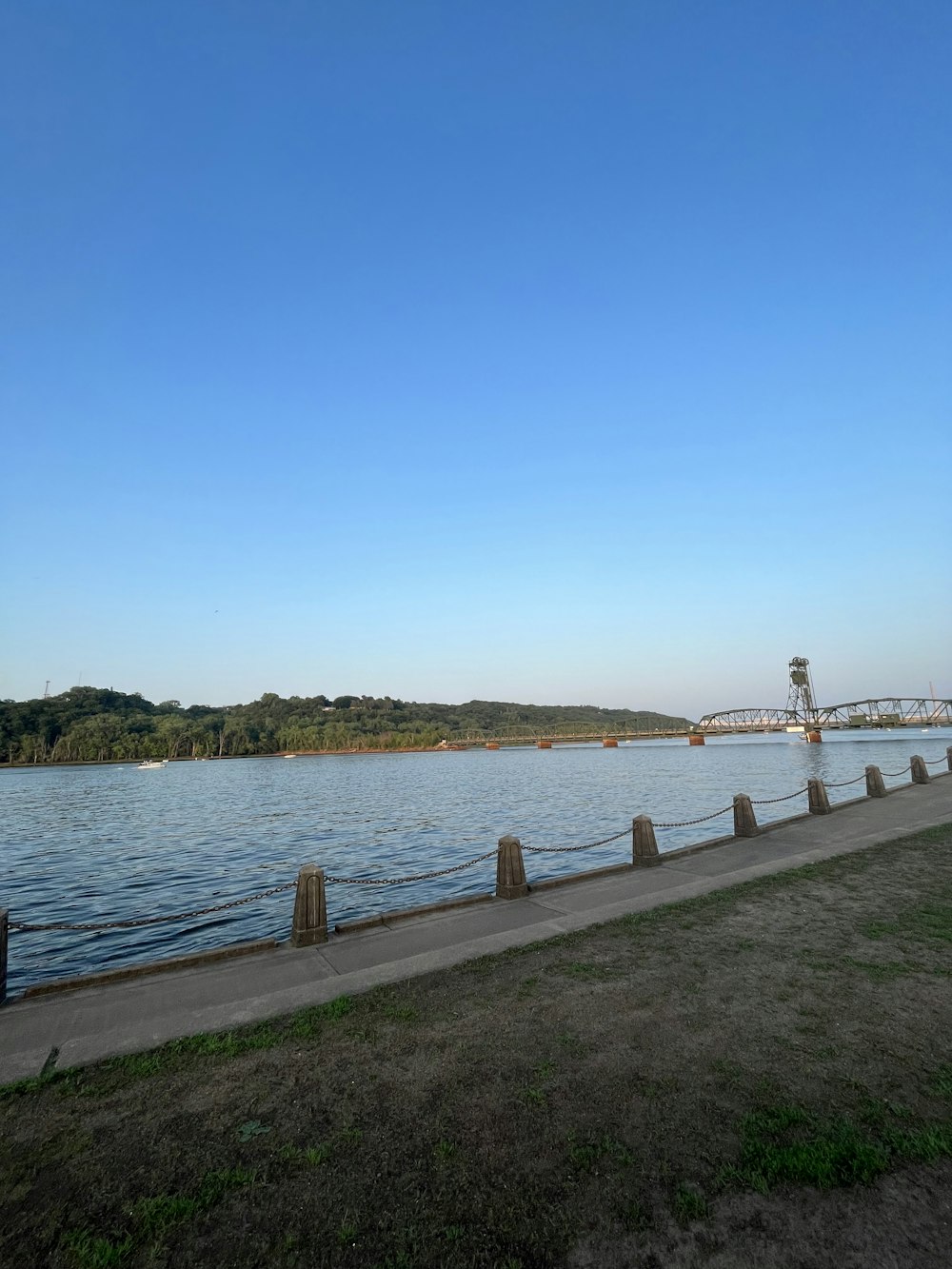 a body of water with a bridge in the background