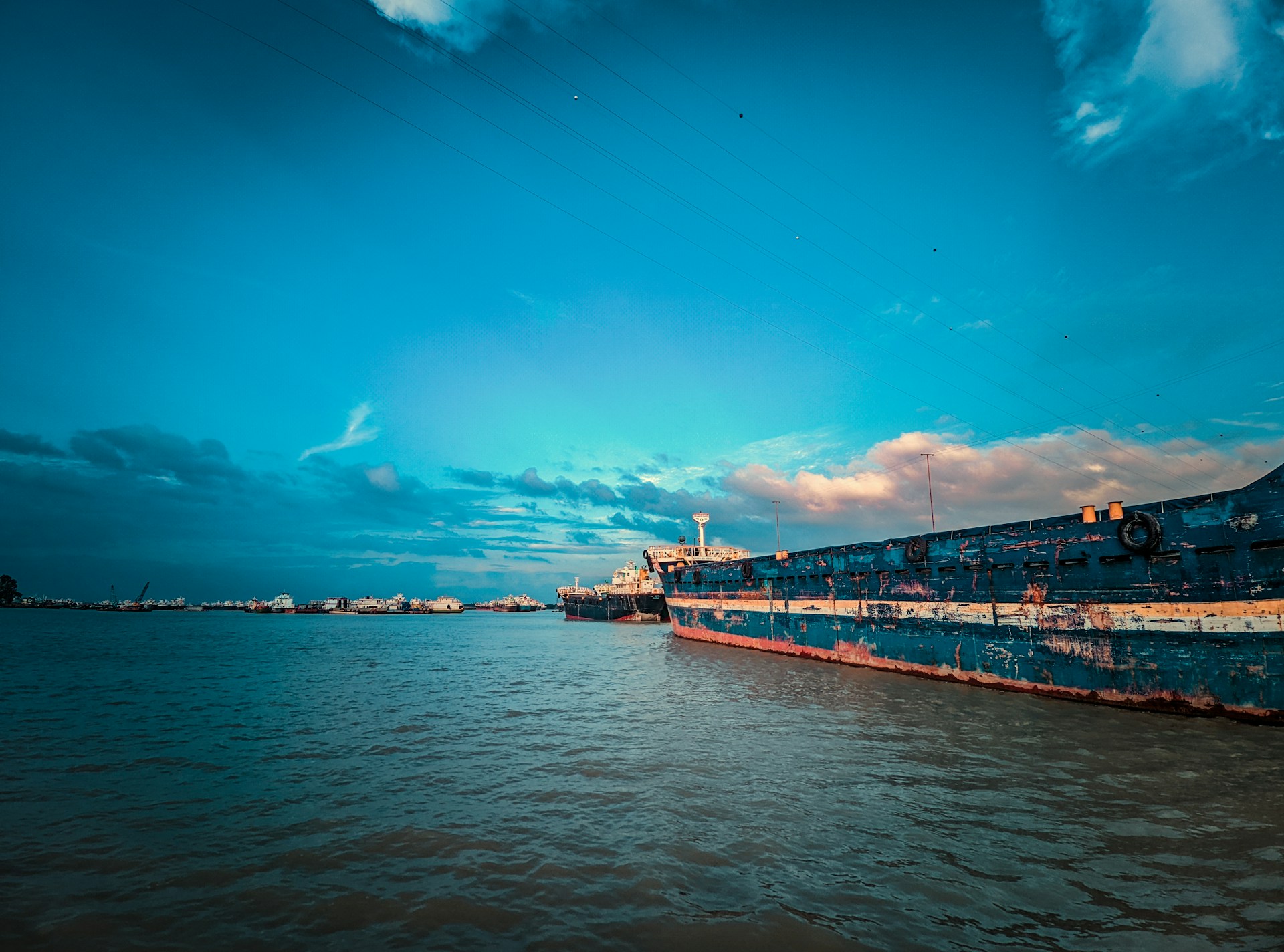A dramatic battleship sailing on the open sea under a moody sky, symbolizing strength and adventure for brawijaya320.