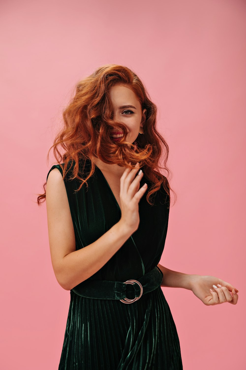 a woman with red hair is posing for a picture
