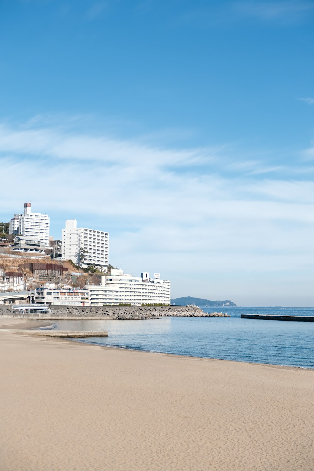 a beach with a city in the background