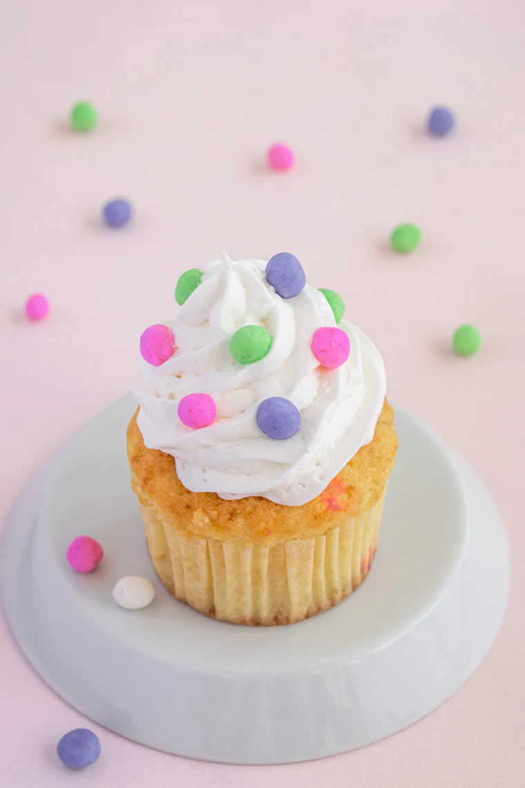 Funfetti cupcakes with white frosting and pastel sprinkles