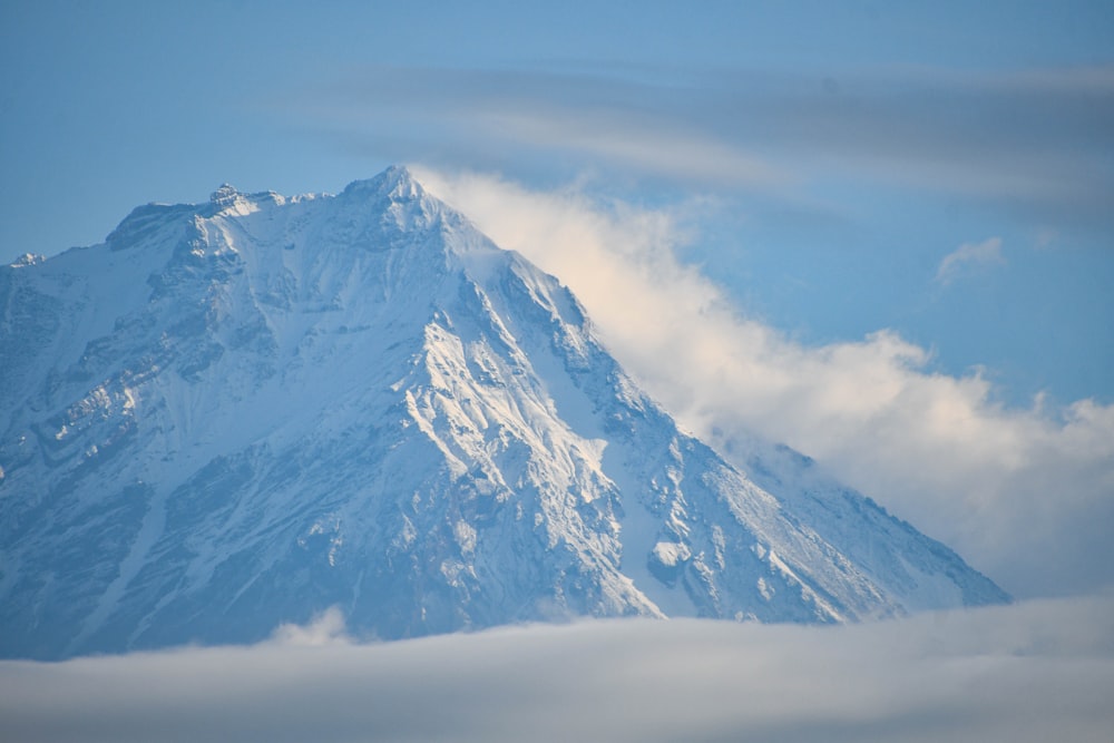 a large snow covered mountain in the middle of the day