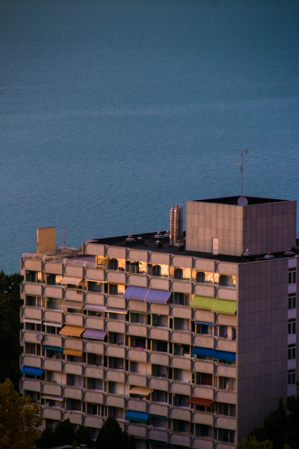 a tall building next to a body of water