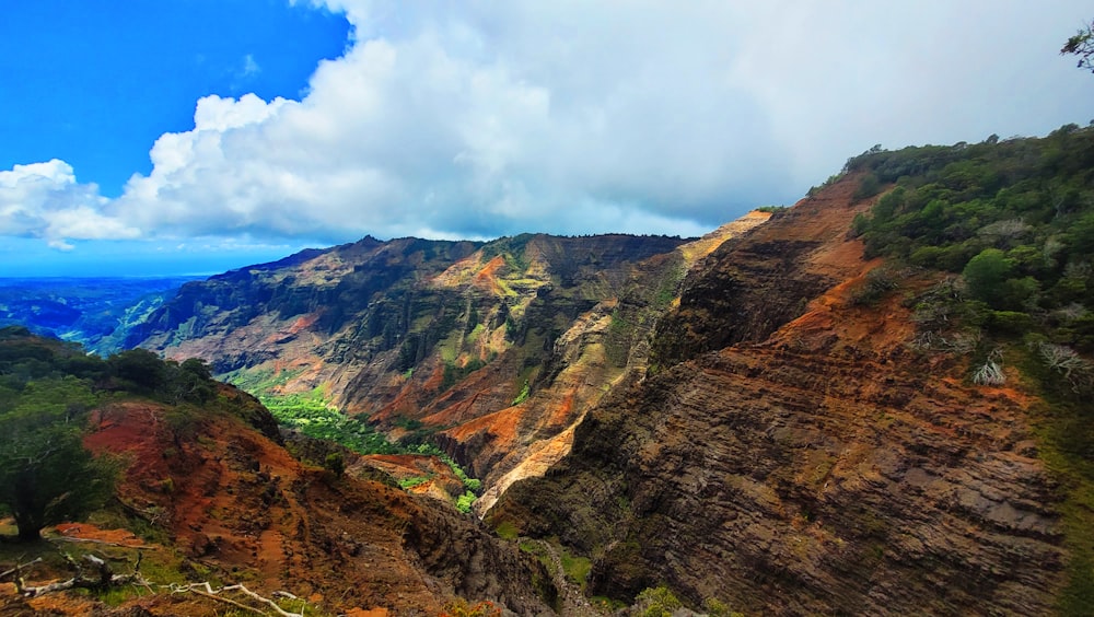 a scenic view of a mountain with a valley below