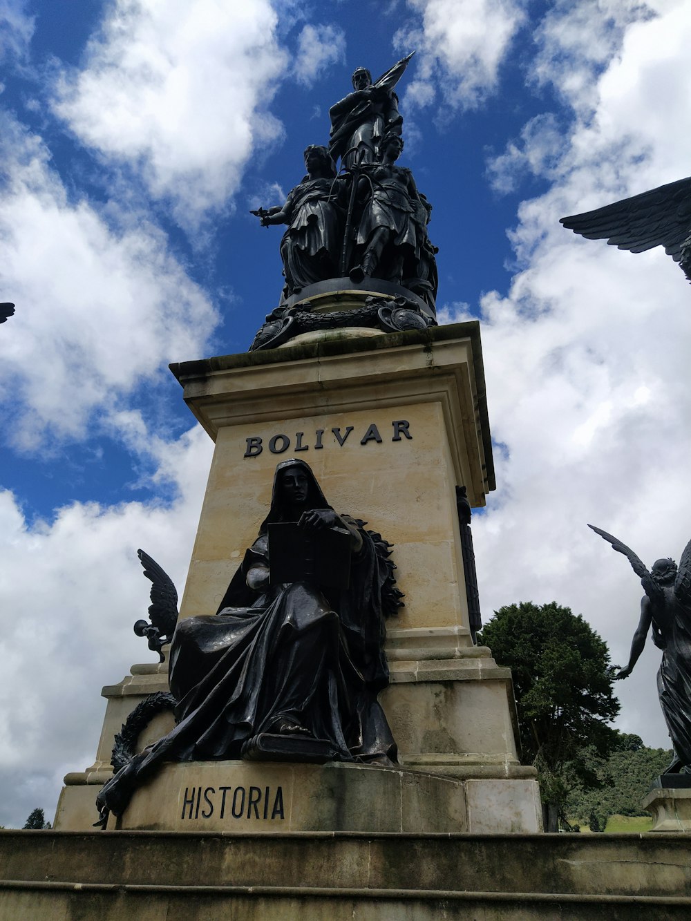 Una estatua de una mujer sentada encima de una estatua