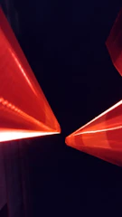 Abstract red particle streams converging into a powerful data core on black.