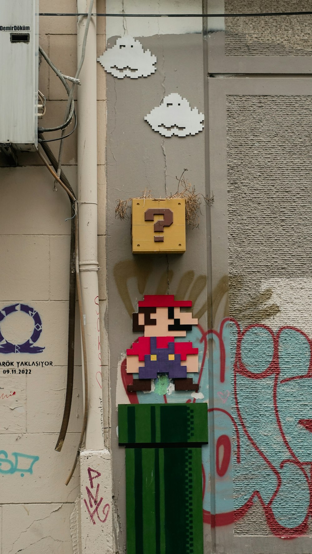 a wall with graffiti and a nintendo character on it