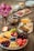 A beautifully arranged gourmet cheese and charcuterie board on a rustic wooden table.