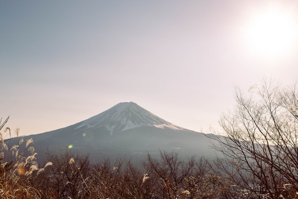 the sun shines brightly on a snowy mountain