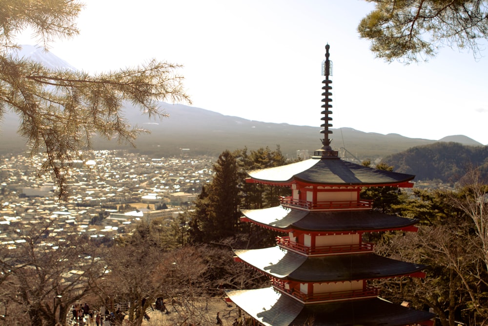 a tall tower sitting on top of a lush green hillside