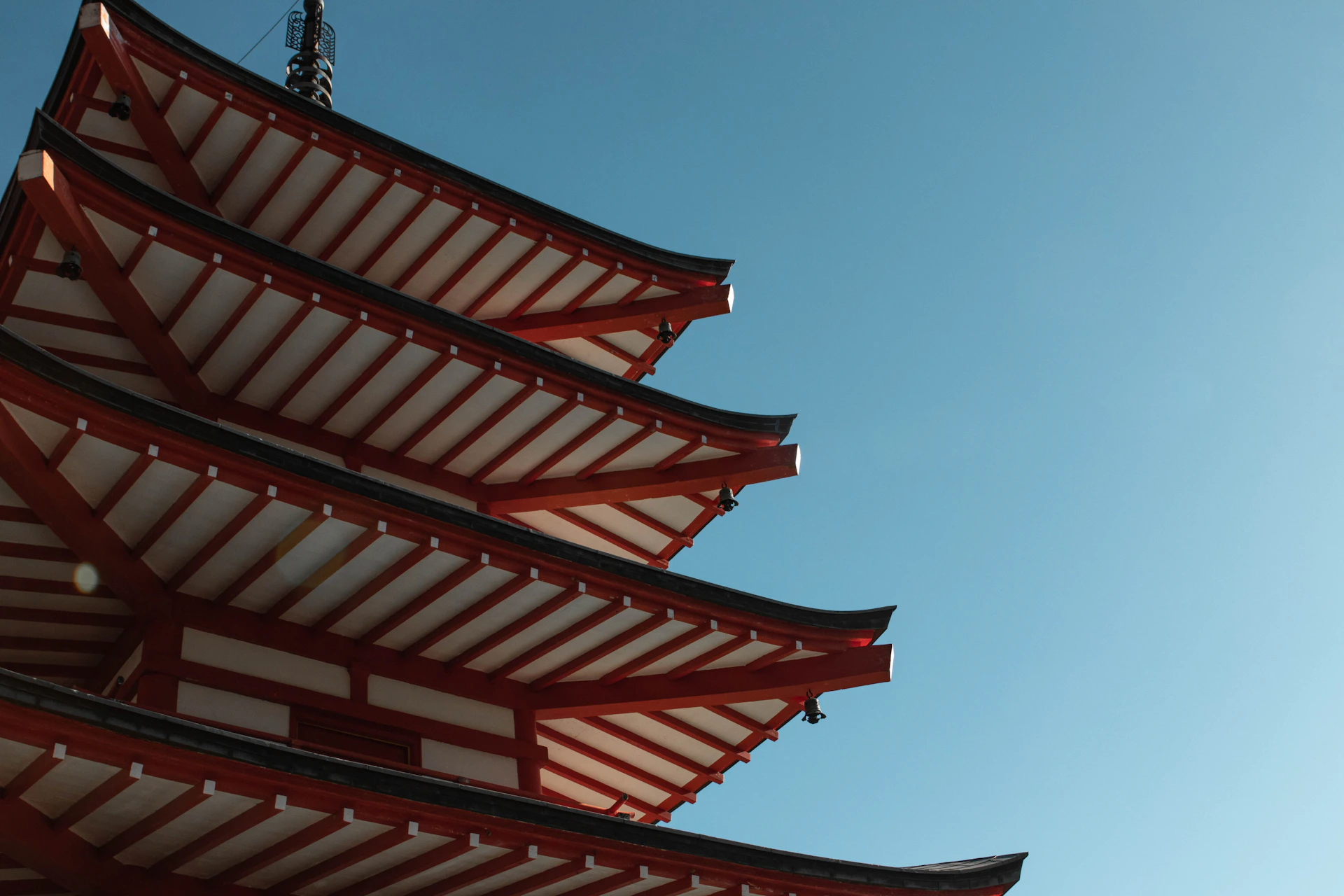 a tall red and white building under a blue sky
