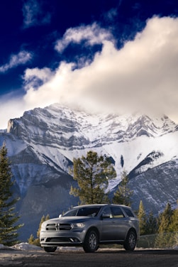 A luxurious vehicle parked in a scenic mountain landscape.
