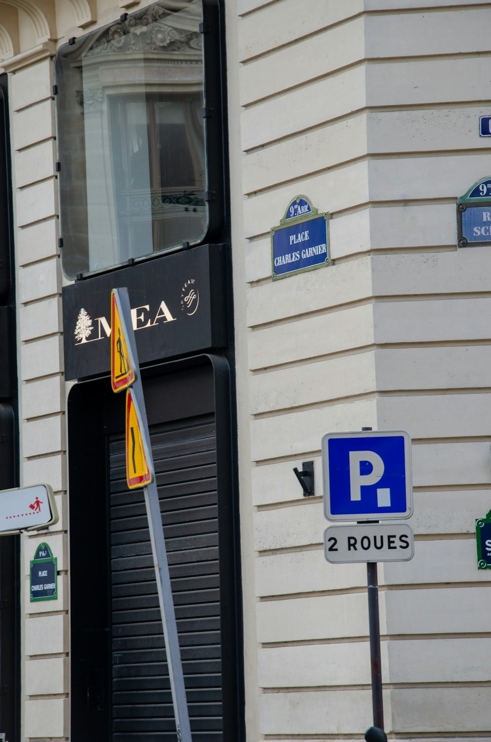 a street sign on a pole in front of a building