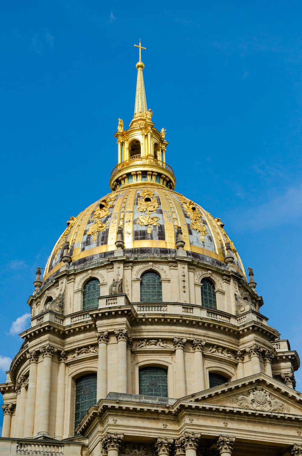 the dome of a building with a golden cross on top