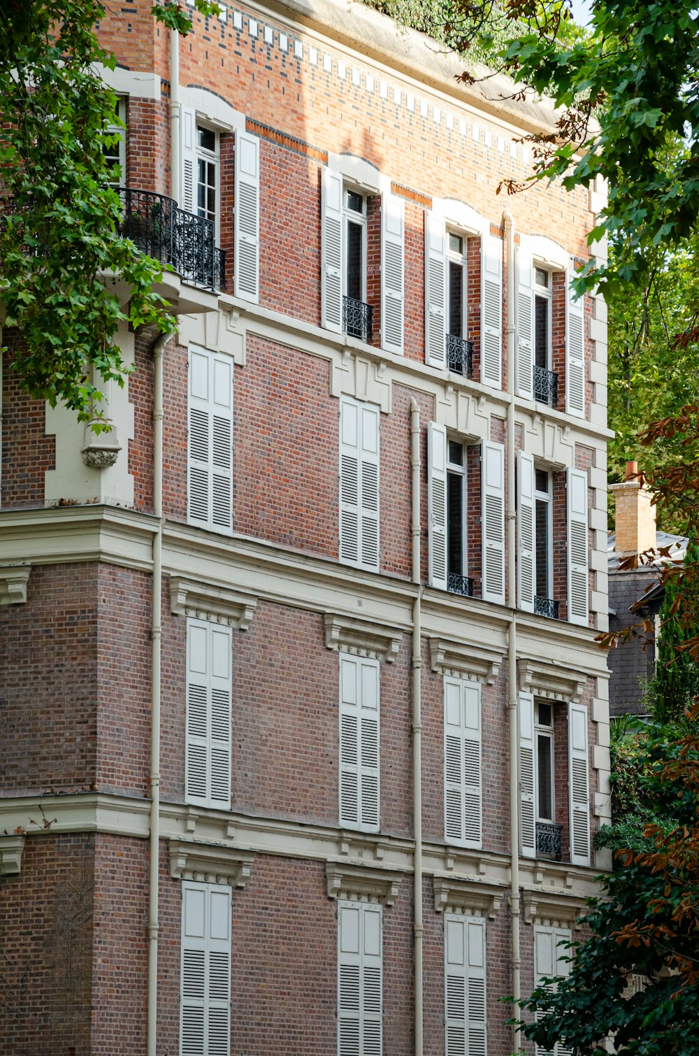 a tall brick building with many windows and balconies