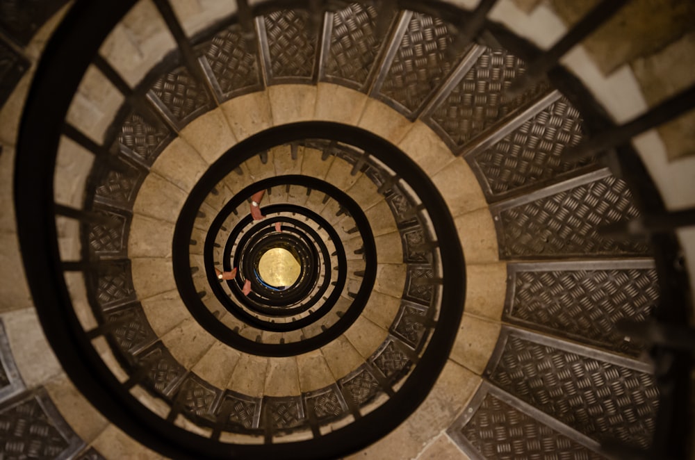 a spiral staircase with a person walking up it