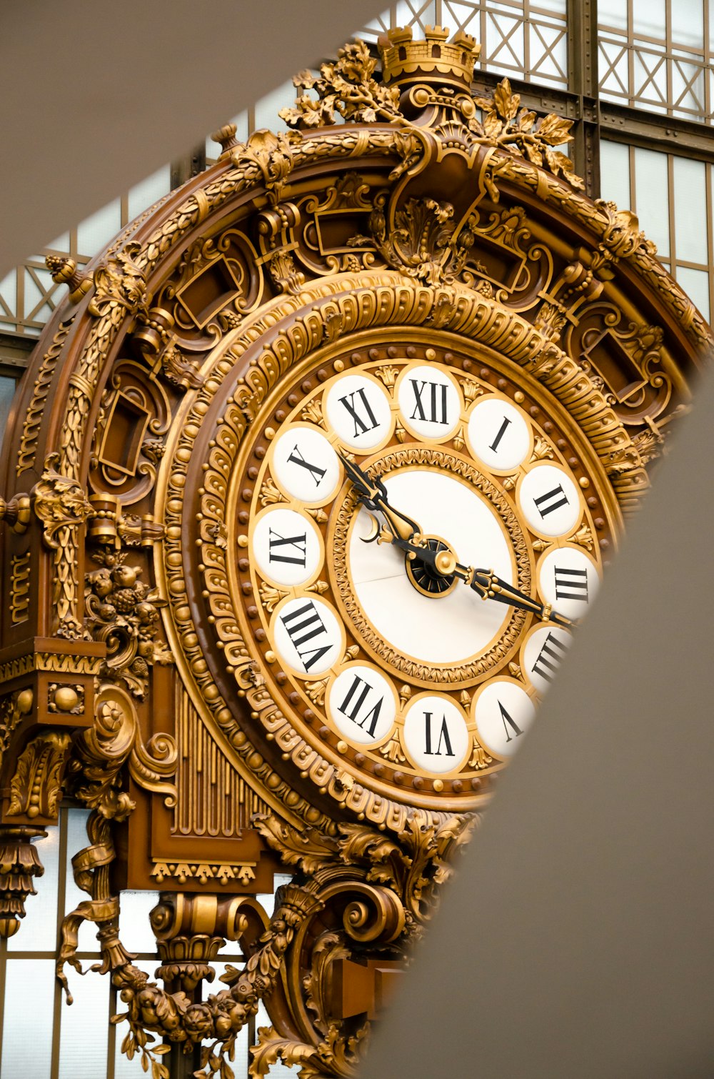 a large gold clock with roman numerals on it