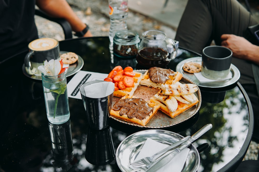 a glass table topped with a plate of food